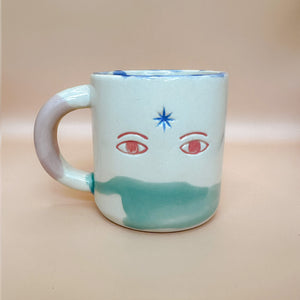 Taza Keep Making Magic - blue star and red eyes